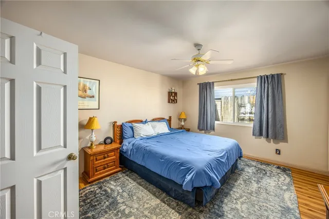 a bedroom with a bed dresser and a window