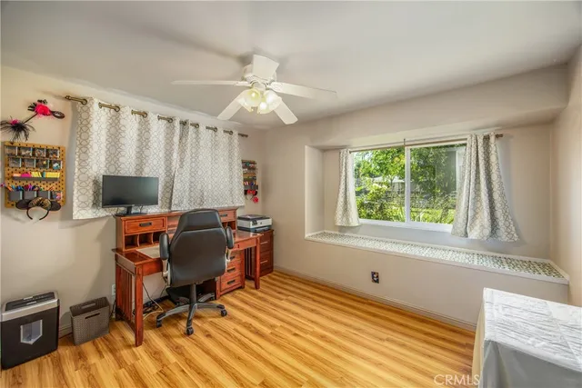 a view of a workspace with furniture and a window