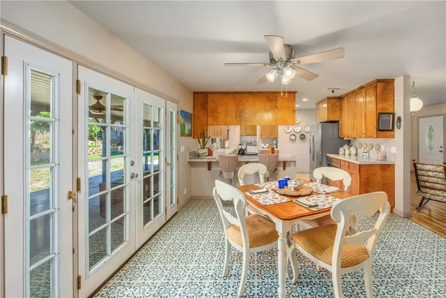 a dining room with furniture a chandelier and window