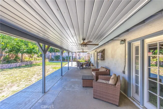 a view of a livingroom with furniture and floor to ceiling window