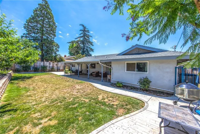 a view of house with swimming pool outdoor seating