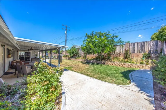 a view of a chair and tables in the backyard