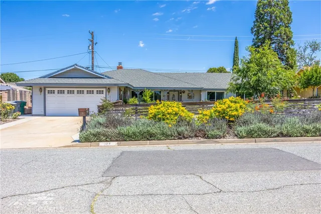 a front view of a house with a yard and a garage