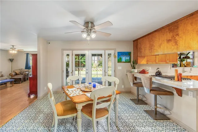 a dining room with furniture a rug and a large window