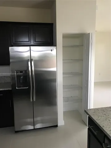 a refrigerator freezer sitting inside of a kitchen