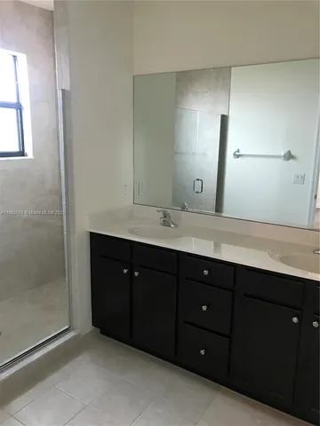 a bathroom with a glass shower door