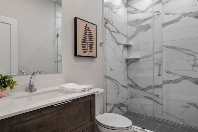 a bathroom with a sink toilet and shower