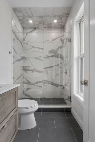 a bathroom with a toilet and shower