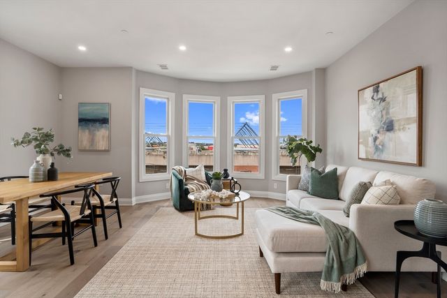 a living room with furniture and floor to ceiling window