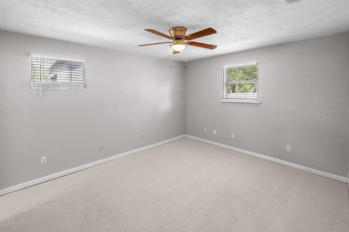 16766 Lake Circle Conroe, TX 77302 - Photo 12 of 22 an empty room with a window and a ceiling fan
