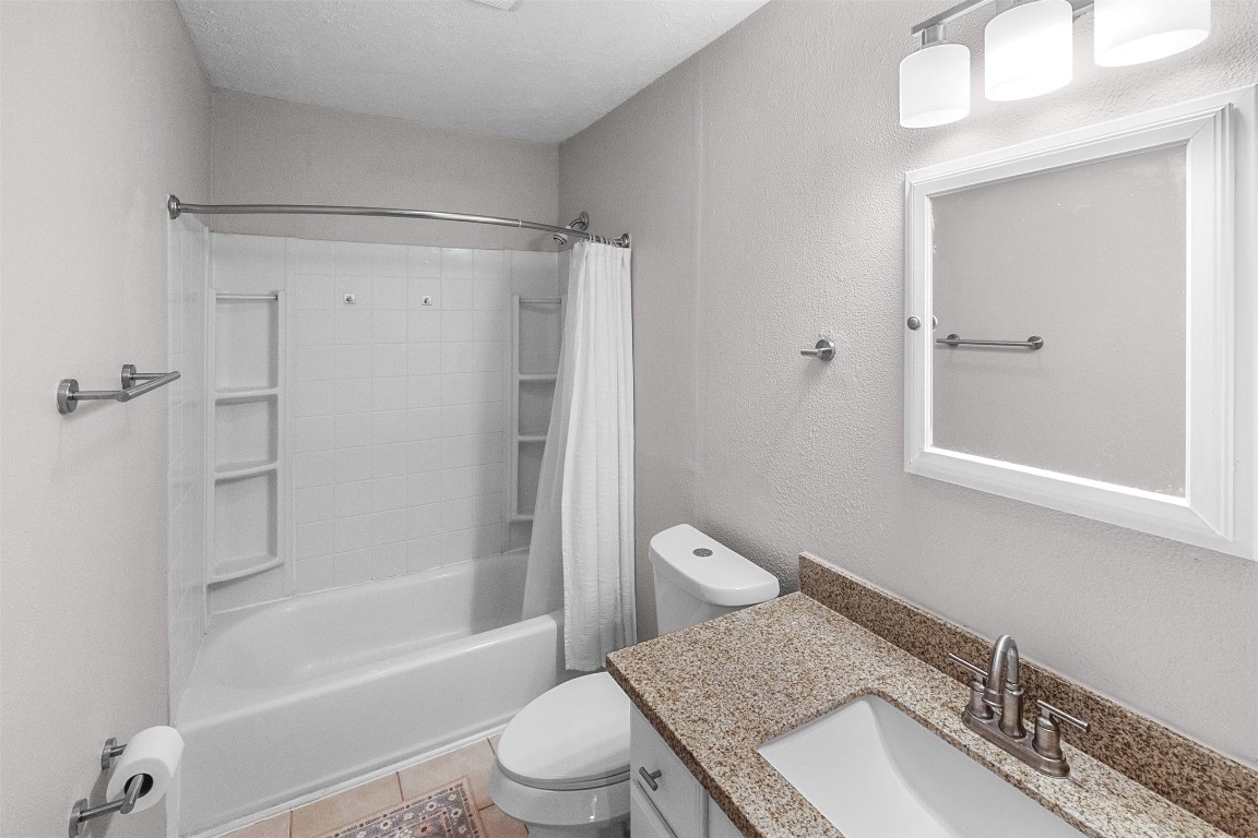 16766 Lake Circle Conroe, TX 77302 - Photo 17 of 22 a bathroom with a granite countertop toilet sink and shower