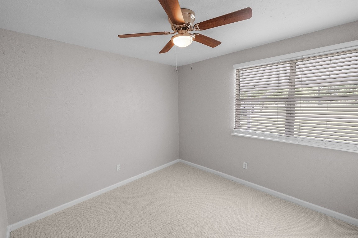 16766 Lake Circle Conroe, TX 77302 - Photo 18 of 22 an empty room with a window and a fan