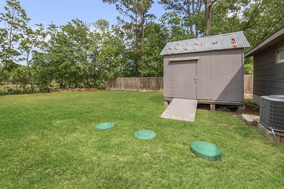 16766 Lake Circle Conroe, TX 77302 - Photo 21 of 22 a view of a tiny house with backyard