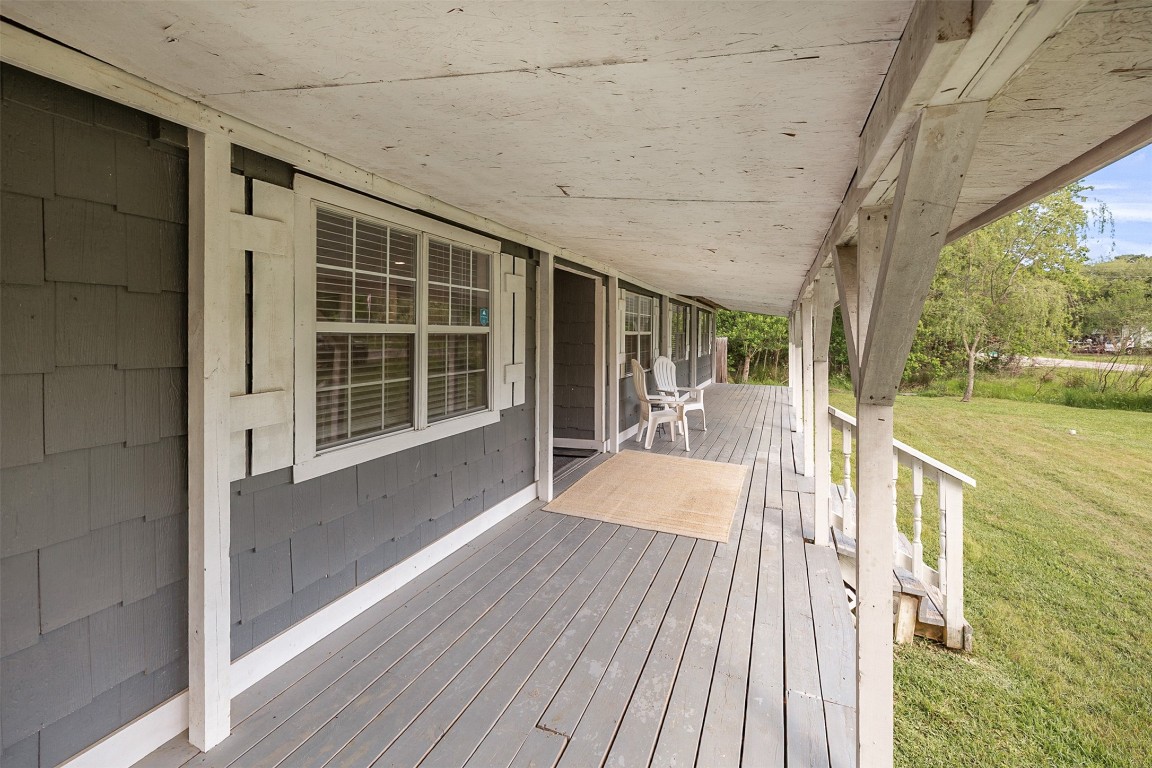 16766 Lake Circle Conroe, TX 77302 - Photo 3 of 22 a view of balcony with floor to ceiling windows and wooden floor