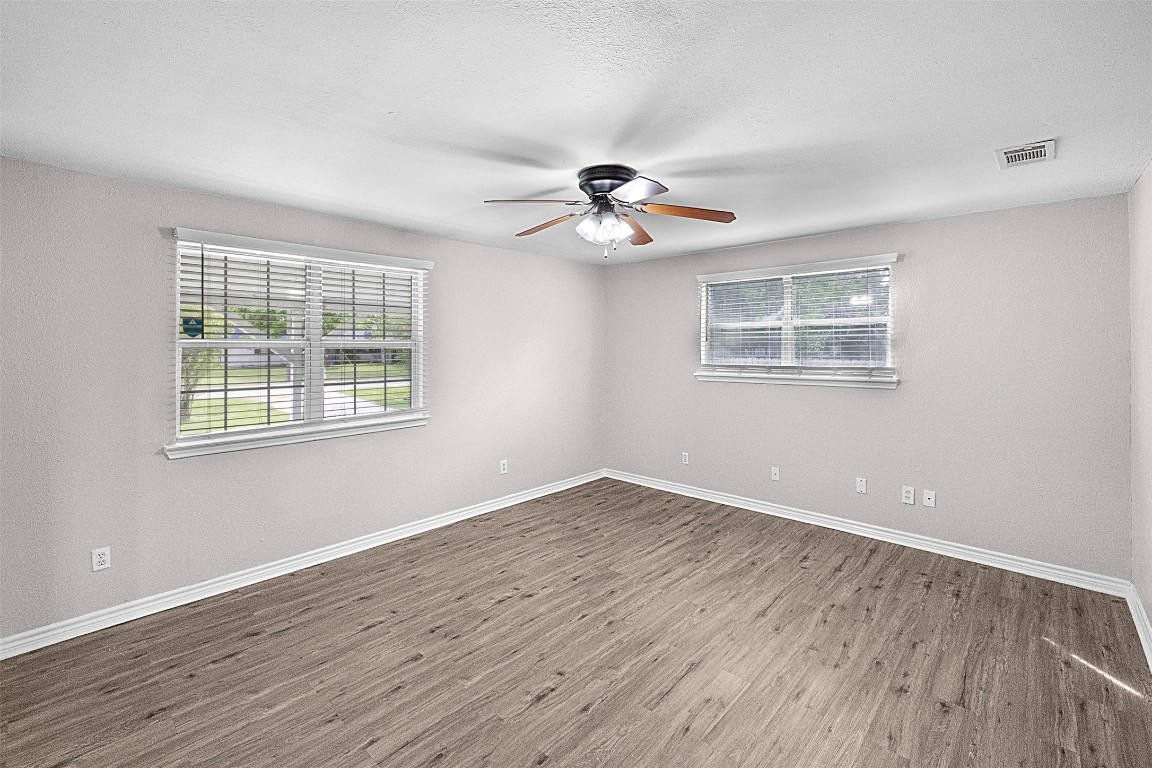 16766 Lake Circle Conroe, TX 77302 - Photo 4 of 22 a view of an empty room with a window and wooden floor