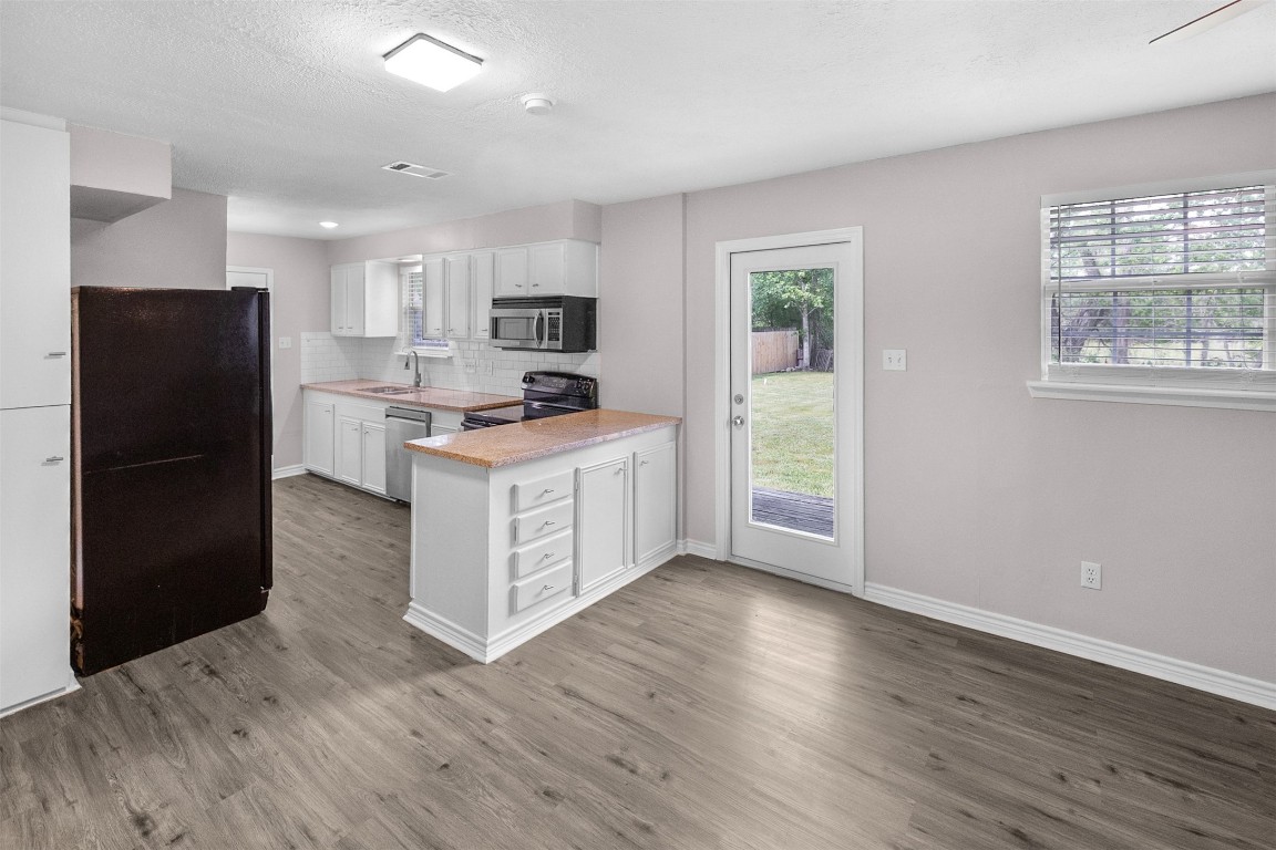 16766 Lake Circle Conroe, TX 77302 - Photo 6 of 22 a kitchen with stainless steel appliances granite countertop a refrigerator a stove a sink and a window