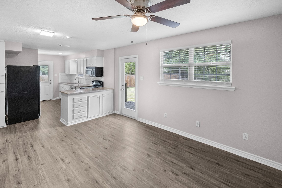 16766 Lake Circle Conroe, TX 77302 - Photo 7 of 22 a view of kitchen with wooden floor and window
