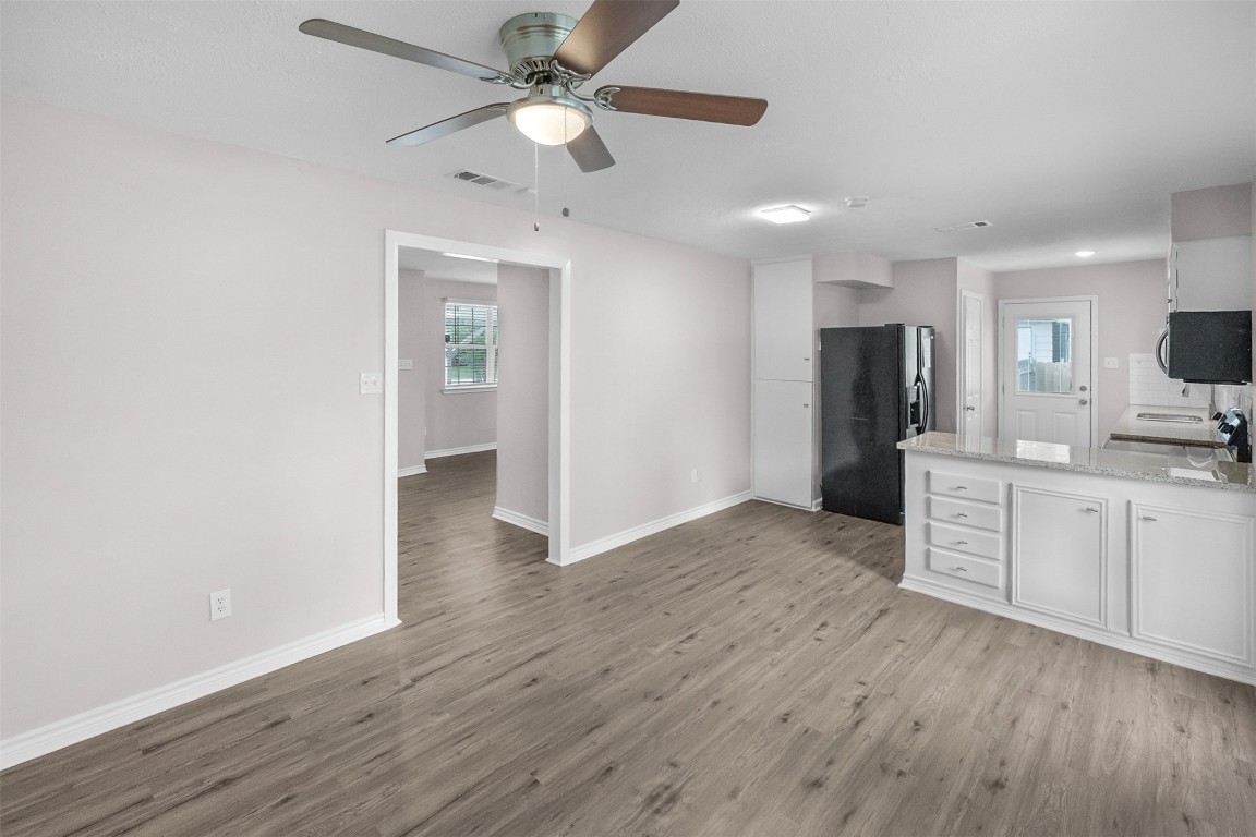 16766 Lake Circle Conroe, TX 77302 - Photo 8 of 22 a view of a kitchen with a sink a refrigerator and wooden floor