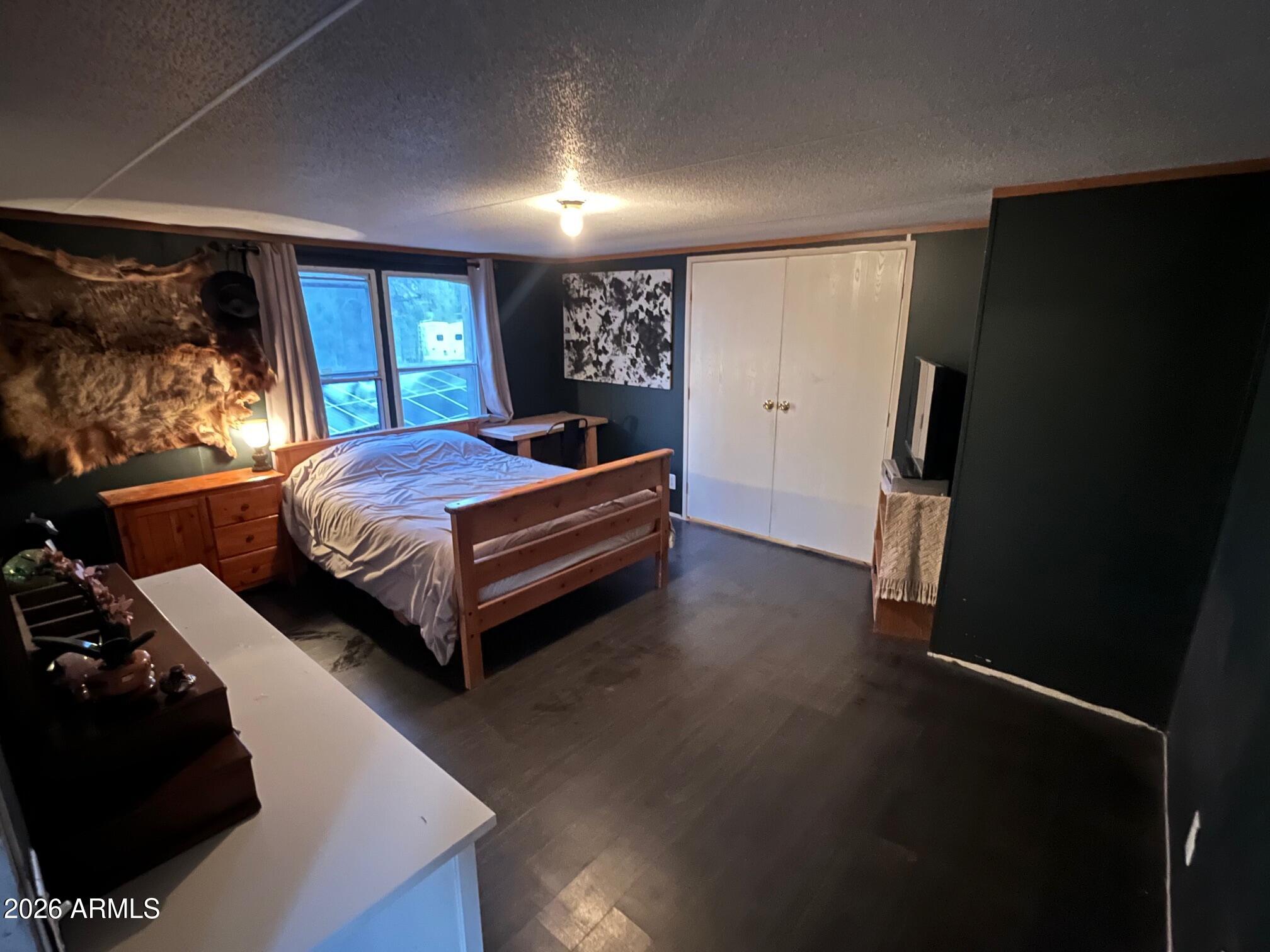 93 Erickson Street Parks, AZ 86005 - Photo 12 of 32 a bedroom with a bed and a large window