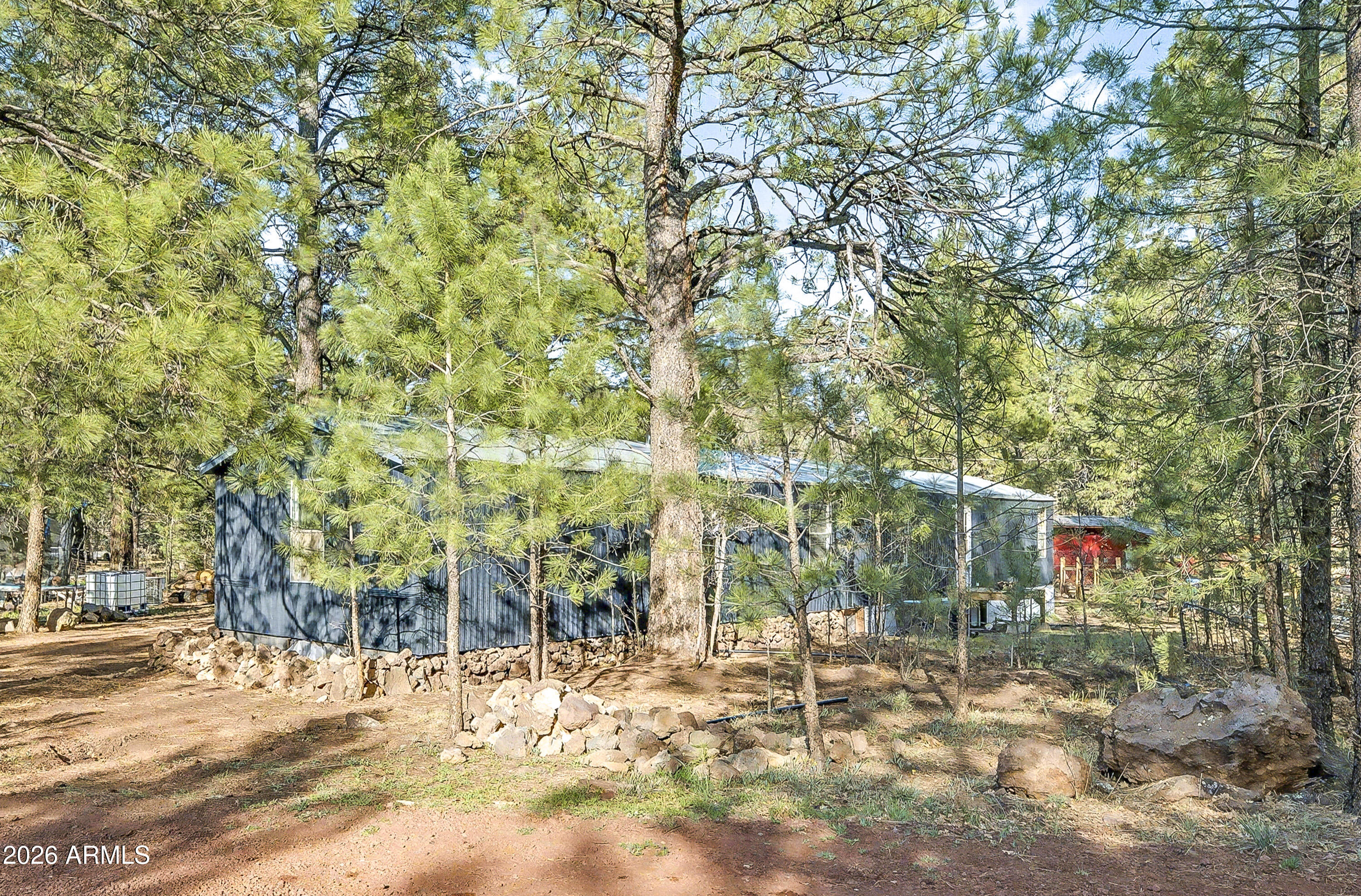 93 Erickson Street Parks, AZ 86005 - Photo 19 of 32 a backyard of a building with large trees