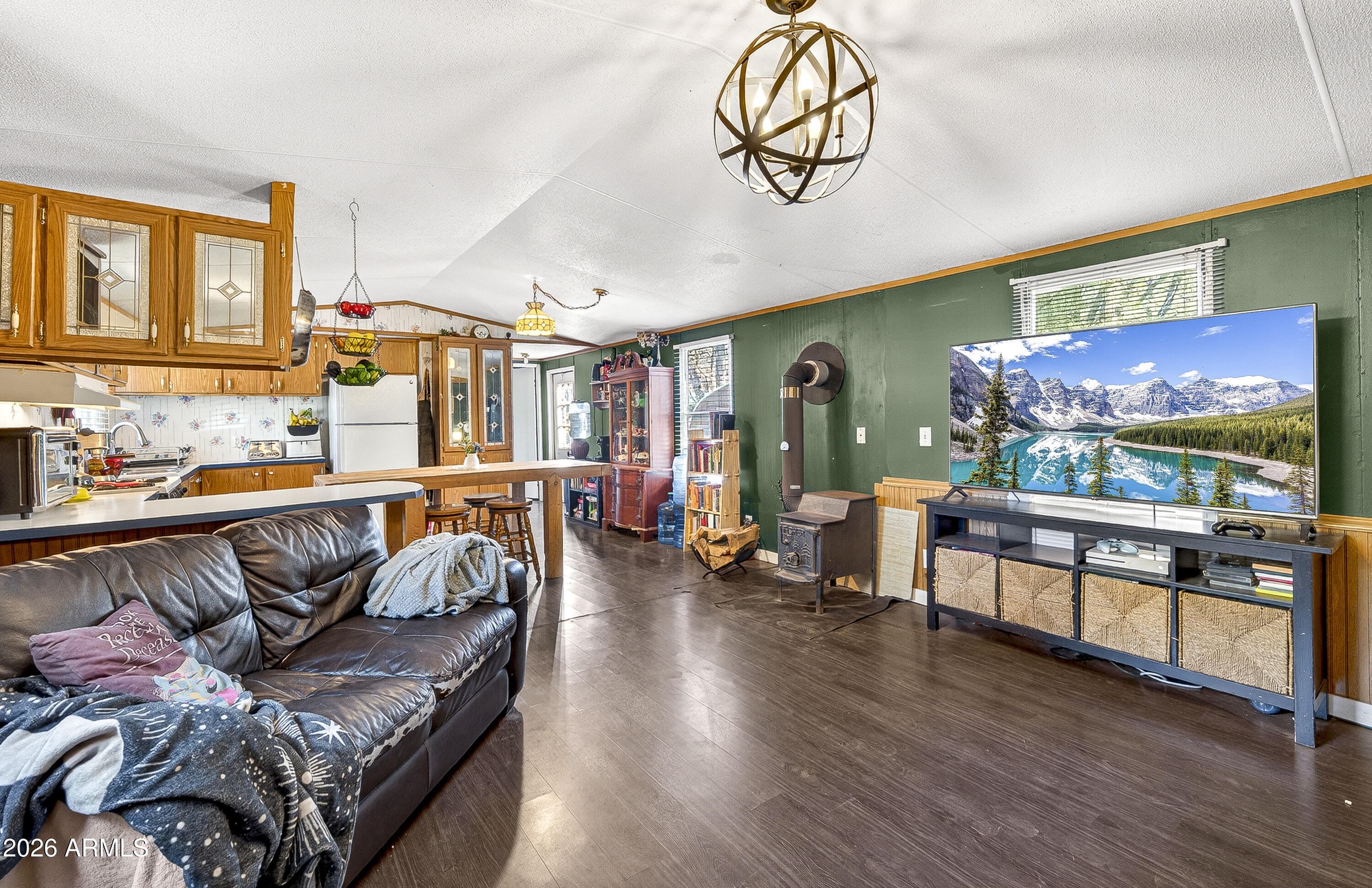 93 Erickson Street Parks, AZ 86005 - Photo 25 of 32 a living room with furniture and a flat screen tv