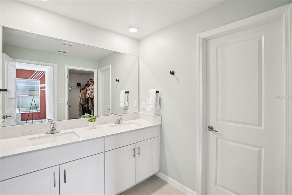 22162 Nebula Way Land O Lakes, FL 34637 - Photo 20 of 44 a bathroom with a double vanity sink and mirror