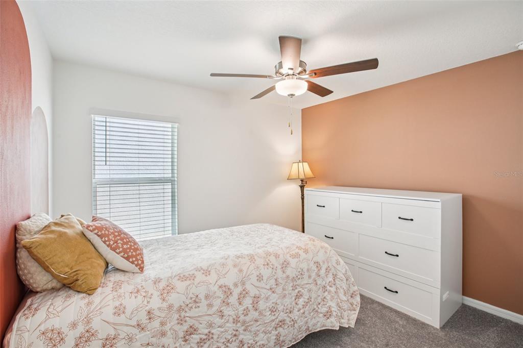 22162 Nebula Way Land O Lakes, FL 34637 - Photo 23 of 44 a bedroom with a bed and a ceiling fan