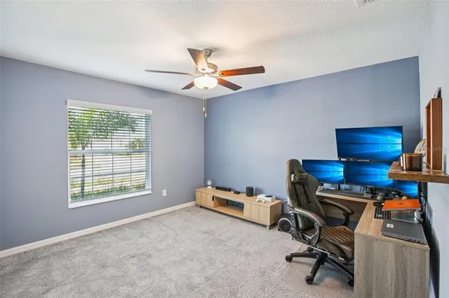 a view of a workspace with furniture and a window