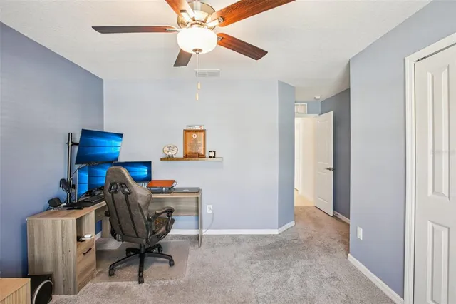 a view of workspace with a ceiling fan