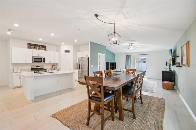 a kitchen with stainless steel appliances a refrigerator stove microwave and sink