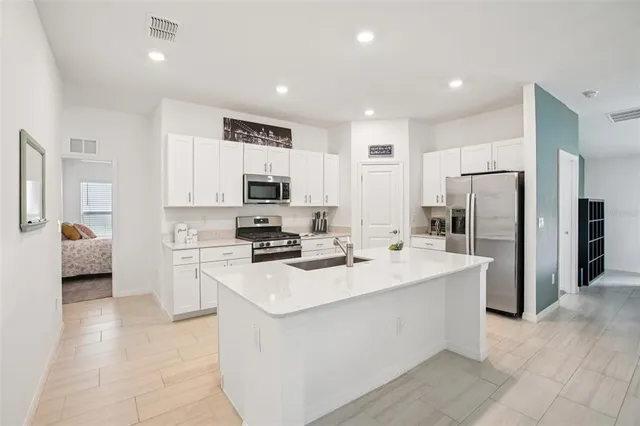 a kitchen with refrigerator and cabinets
