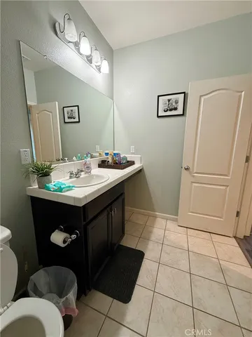 a bathroom with a sink a toilet and mirror