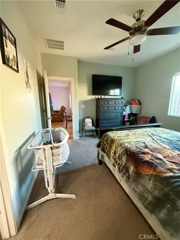 a bedroom with a bed window and couch
