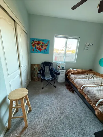 a bedroom with a bed and a chair