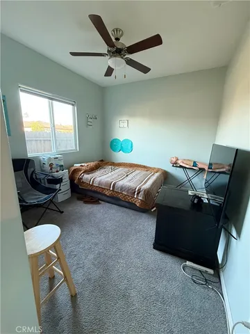 a bedroom with a bed gym equipment and a window