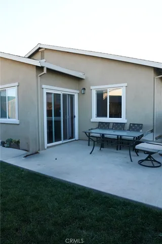 a view of a house with a backyard porch and sitting area