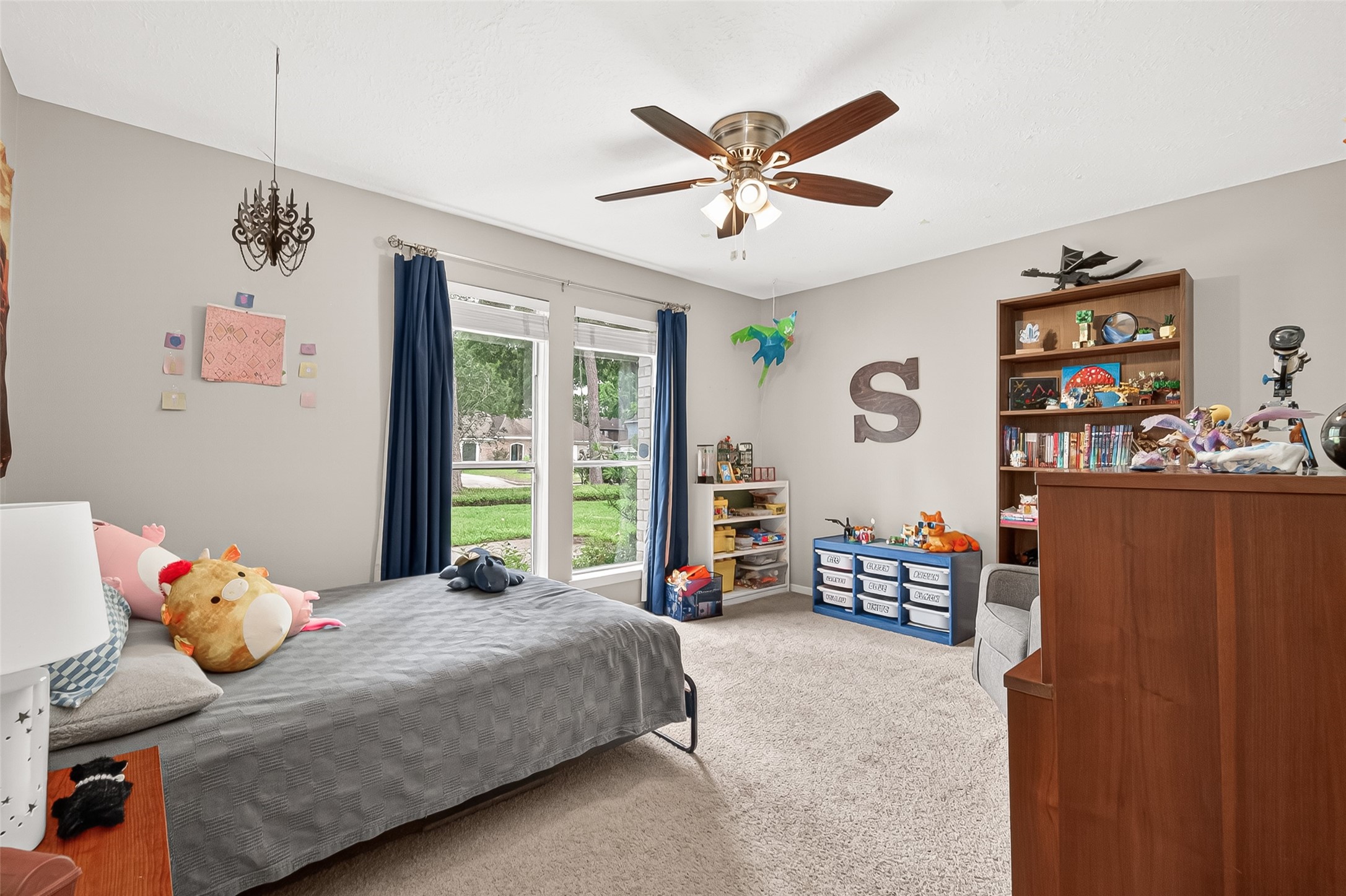 17611 Sorrell Ridge Drive Spring, TX 77388 - Photo 32 of 50 a bedroom with a bed and a chandelier