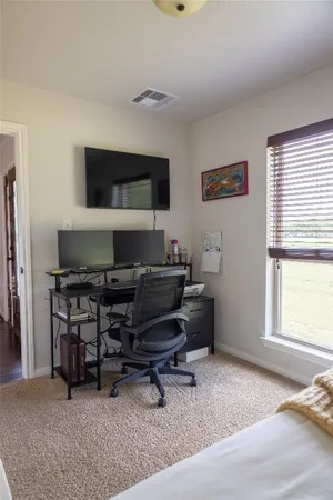 a bedroom with a bed and a tv in it