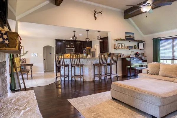 a kitchen with granite countertop a refrigerator and a stove top oven