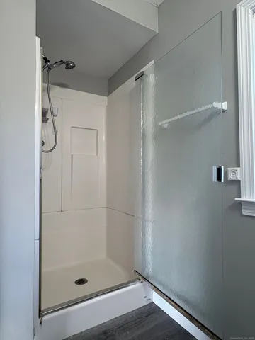 a bathroom with a glass shower door