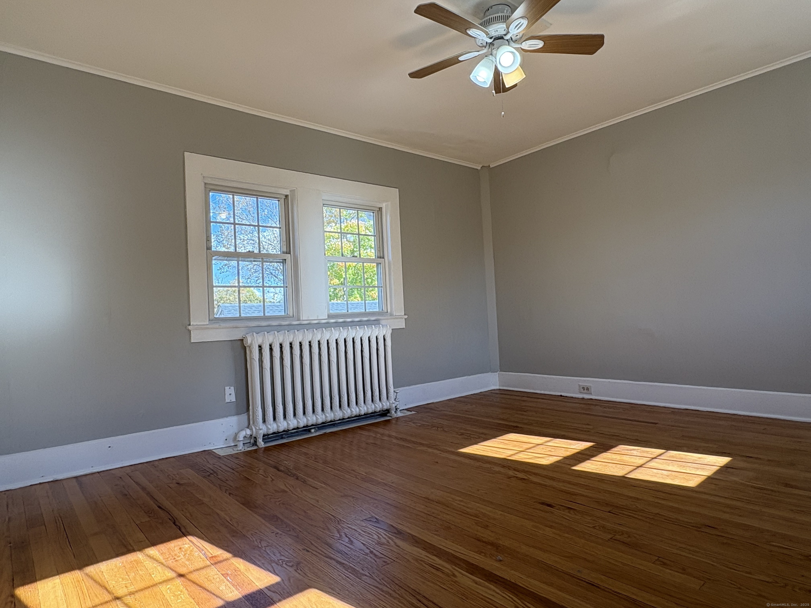 548 Main Street Portland, CT 06480 - Photo 8 of 14 a view of empty room with wooden floor and fan