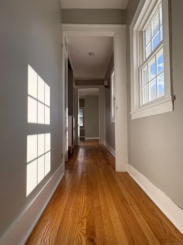a view of a room with wooden floor and windows