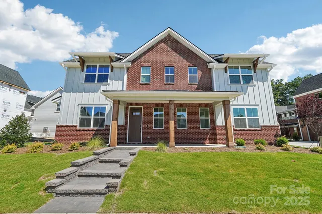a front view of a house with a yard and outdoor seating