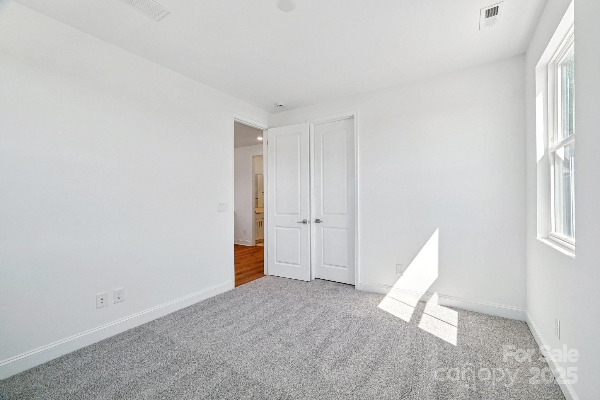609 Mercury Drive Tega Cay, SC 29708 - Photo 13 of 15 a view of an empty room with a window