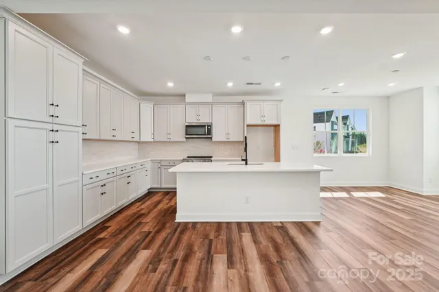 a view of kitchen with sink microwave refrigerator and stove
