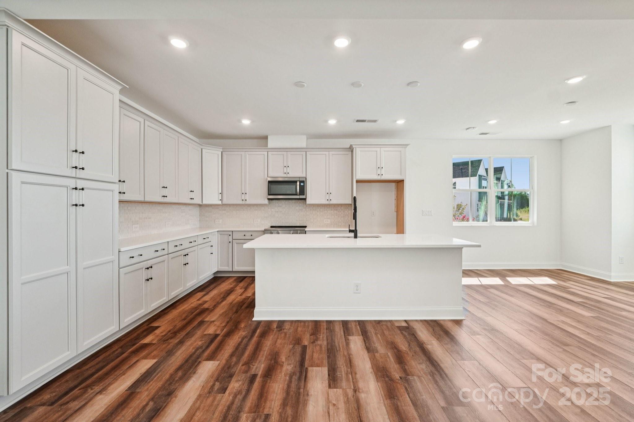 609 Mercury Drive Tega Cay, SC 29708 - Photo 6 of 15 a view of kitchen with sink microwave refrigerator and stove