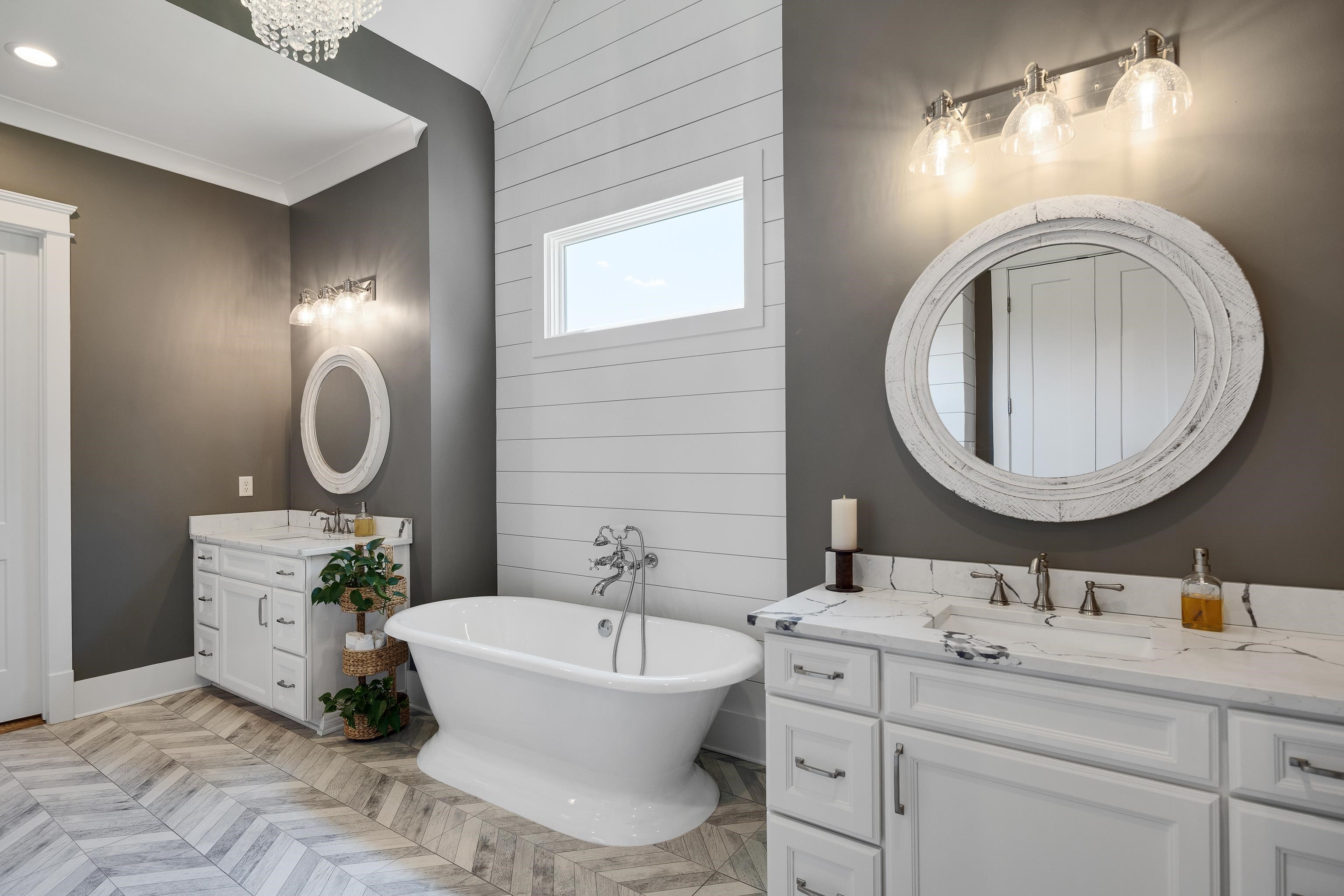 805 Shady Grove Road Williston, TN 38076 - Photo 22 of 40 Freestanding soaking tub, dual white vanities with integrated sinks, wood-finish herringbone flooring, and shiplap accent wall