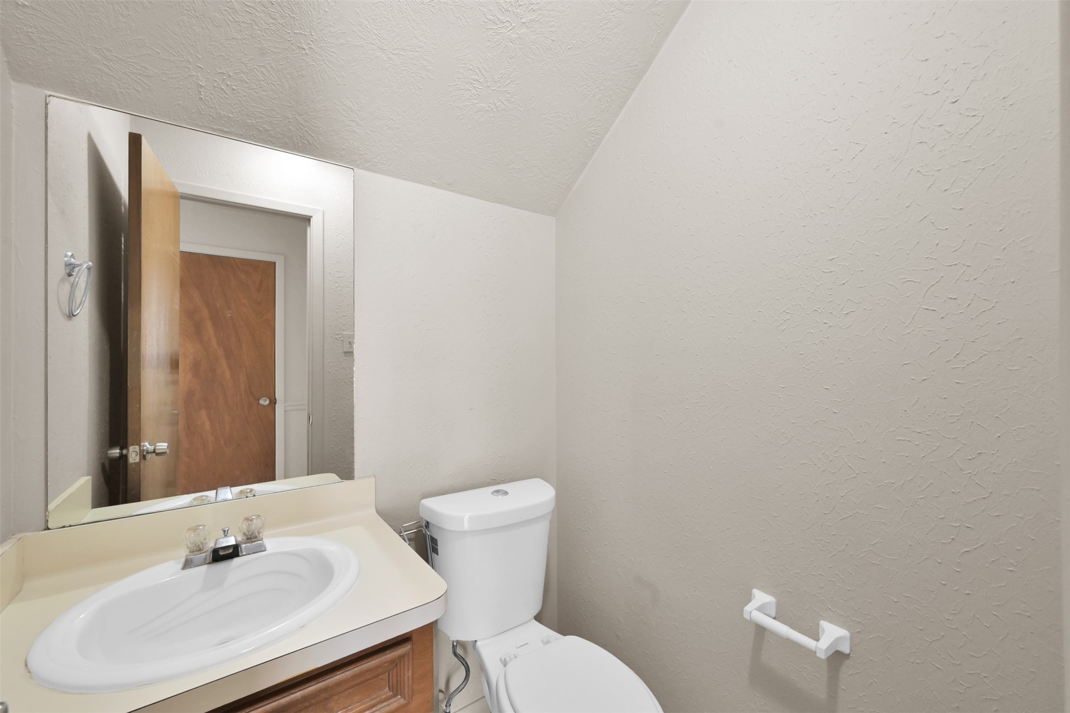 1603 Hazelwood Street, Unit B Conroe, TX 77301 - Photo 13 of 18 a bathroom with a sink mirror and toilet