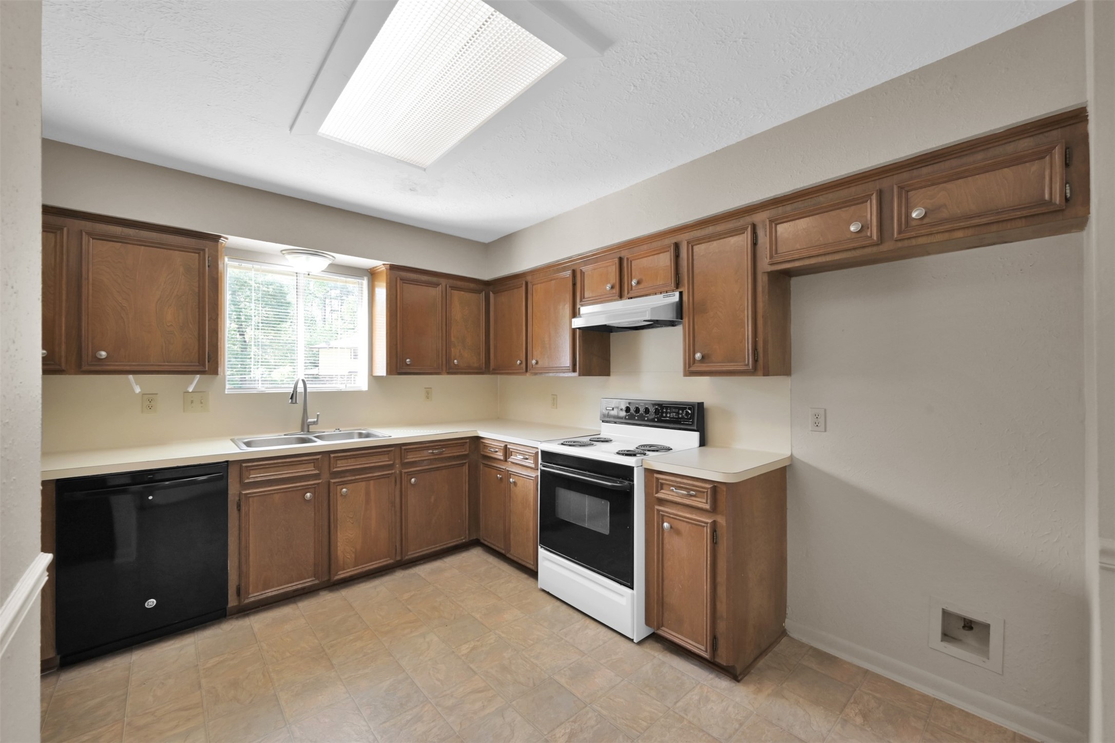 1603 Hazelwood Street, Unit B Conroe, TX 77301 - Photo 4 of 18 a kitchen with a sink stove and cabinets