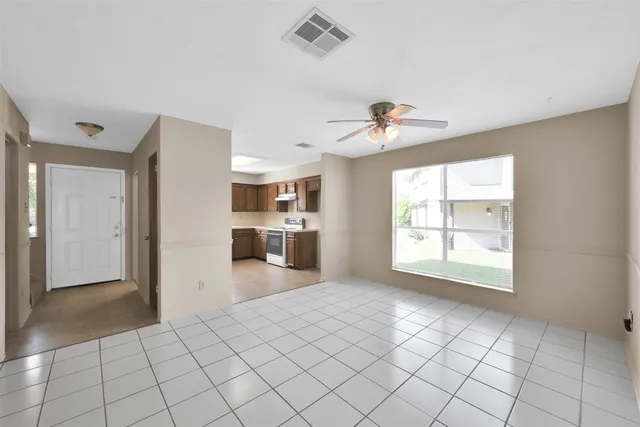 a view of a kitchen with furniture and windows